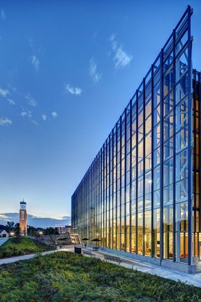 Mary Idema Pew Library with clock tower in the background at sunset